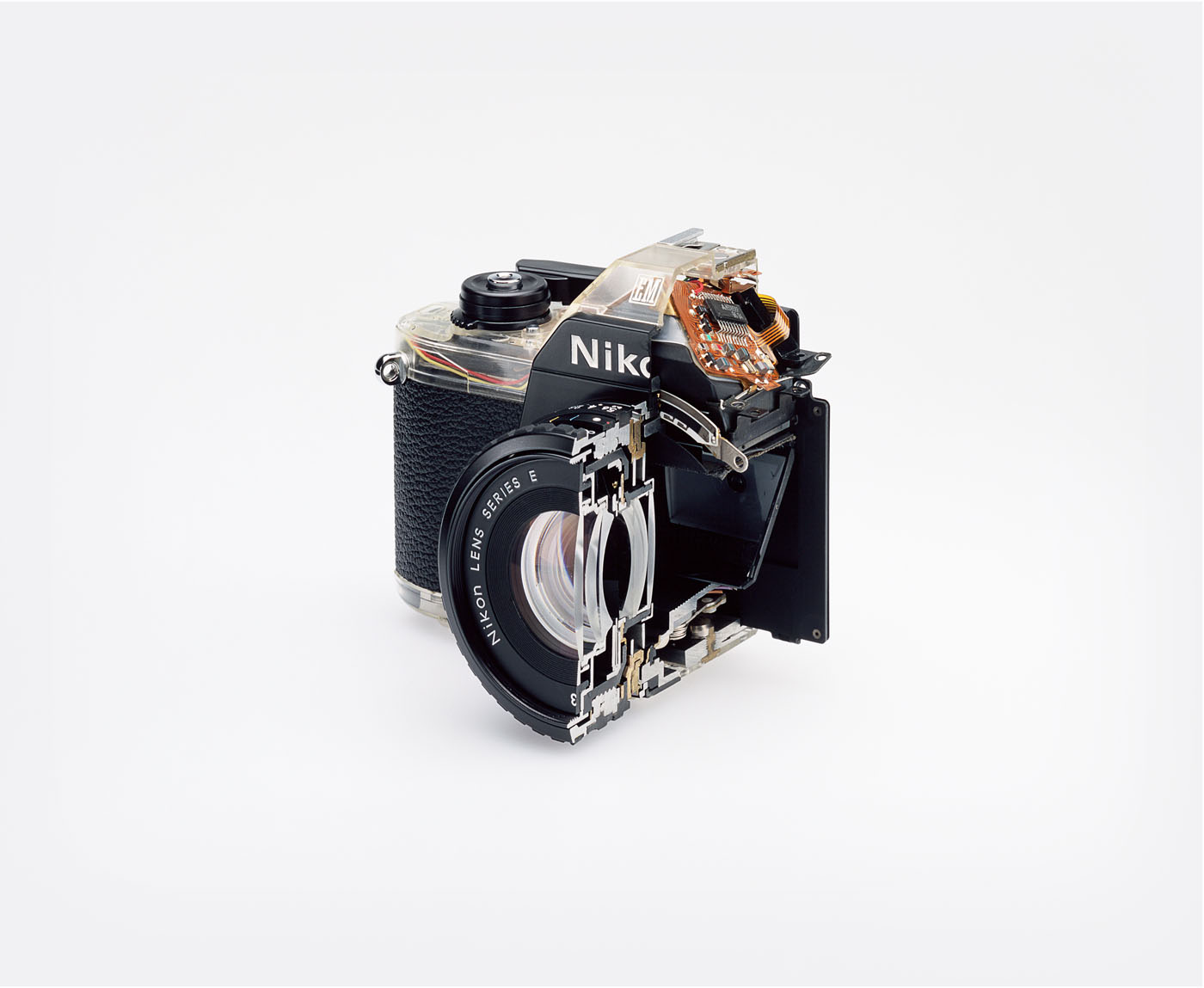 Cutaway model Nikon EM Shutter: Electronically governed Seiko metal blade shutter, vertical travel with speeds from 1/1000 to 1 second, with a manual speed of  1/90th. Meter: Center-weighted Silicon Photo Diode, ASA 25-1600, EV 2-18 (...)